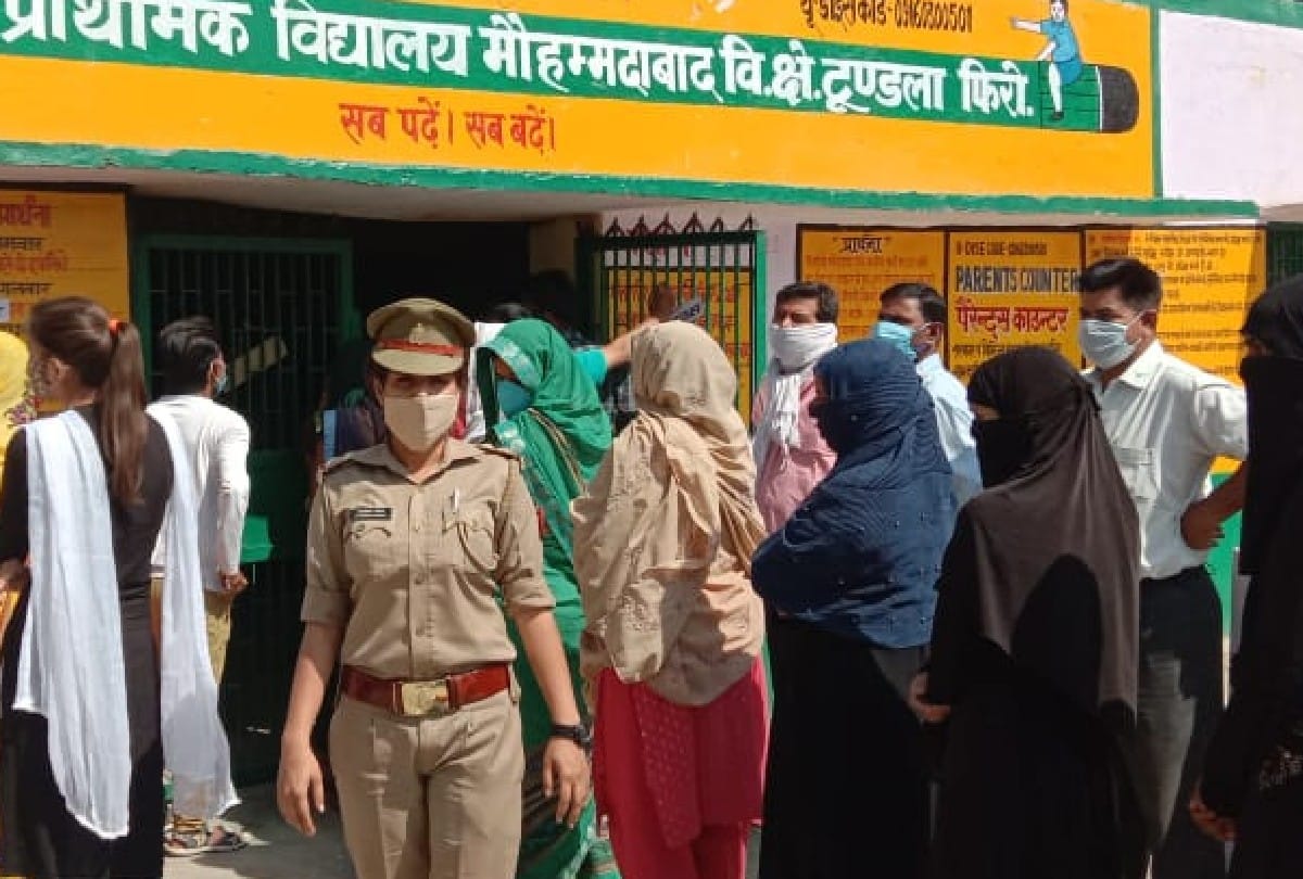 Voters queue outside polling booths as voting for panchayat elections is firozabad