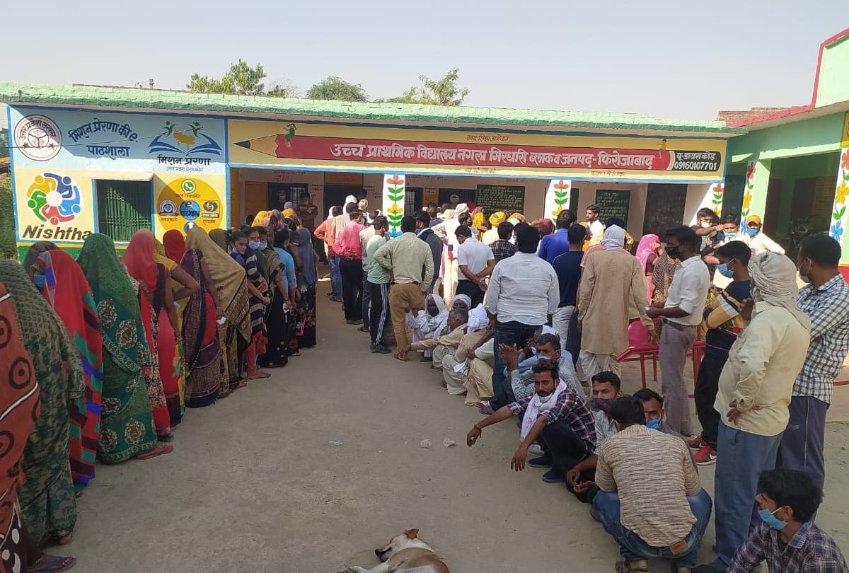 Voters queue outside polling booths as voting for panchayat elections is firozabad