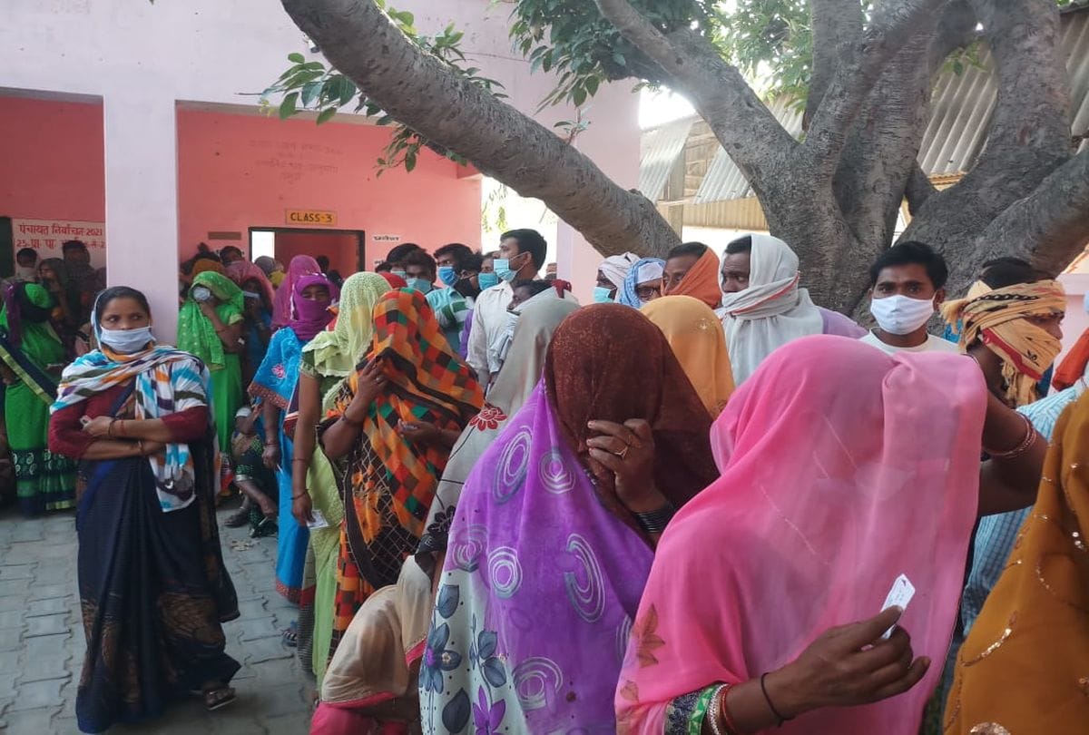 Voters queue outside polling booths as voting for panchayat elections is firozabad