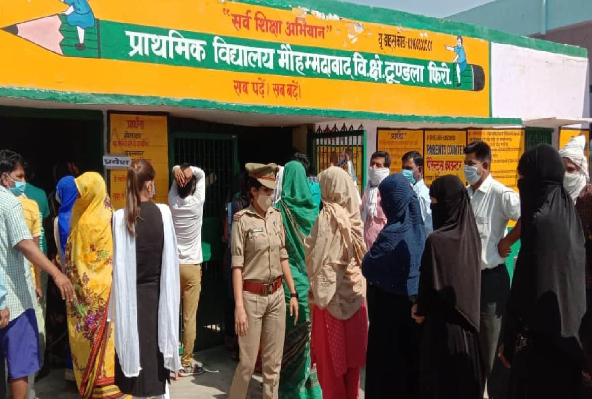 Voters queue outside polling booths as voting for panchayat elections is firozabad
