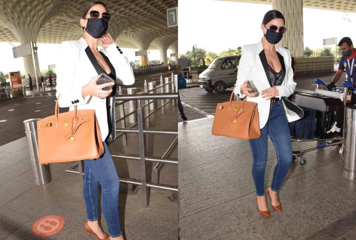 nora fatehi airport look in black corset top with white blazer and jeans