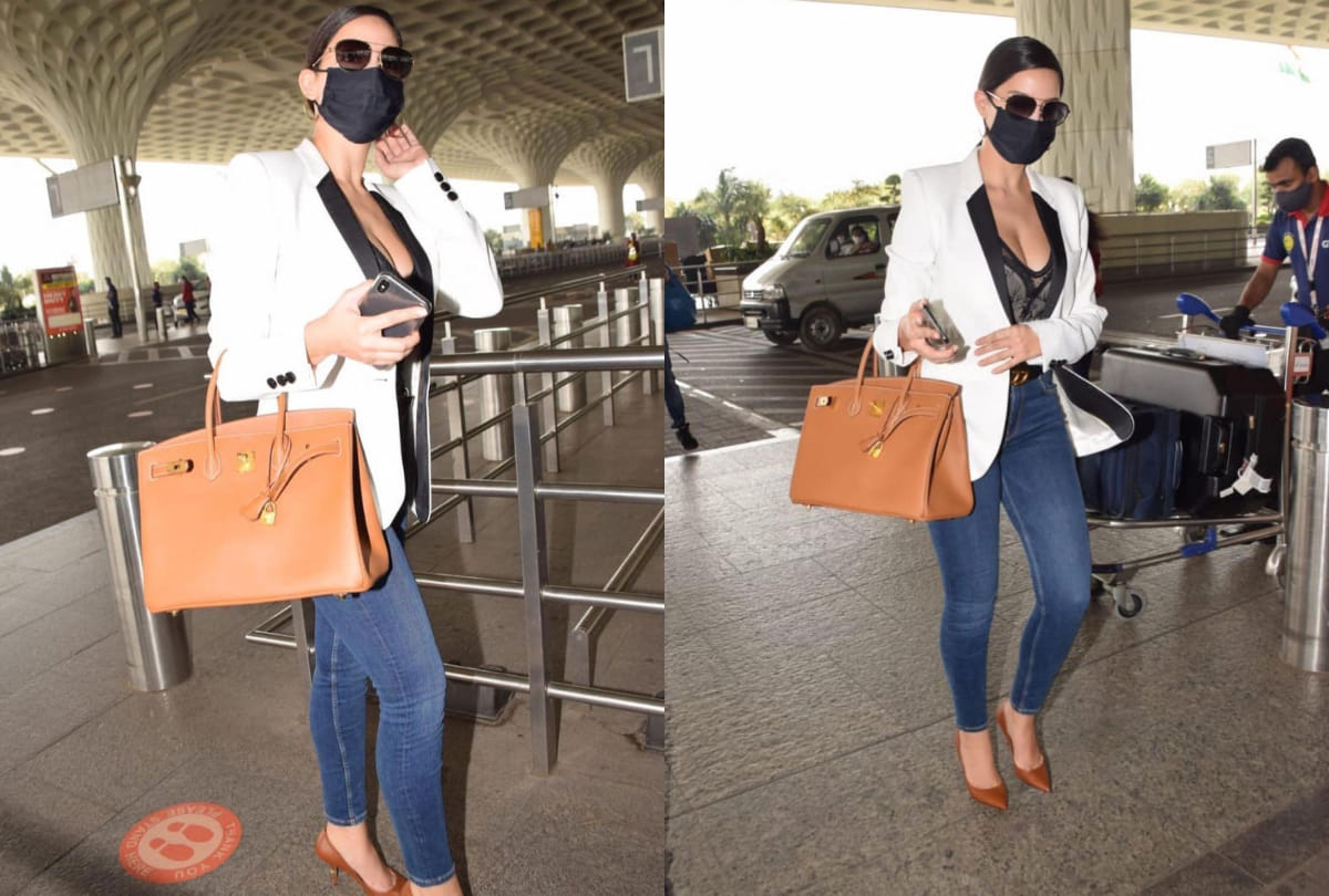 nora fatehi airport look in black corset top with white blazer and jeans
