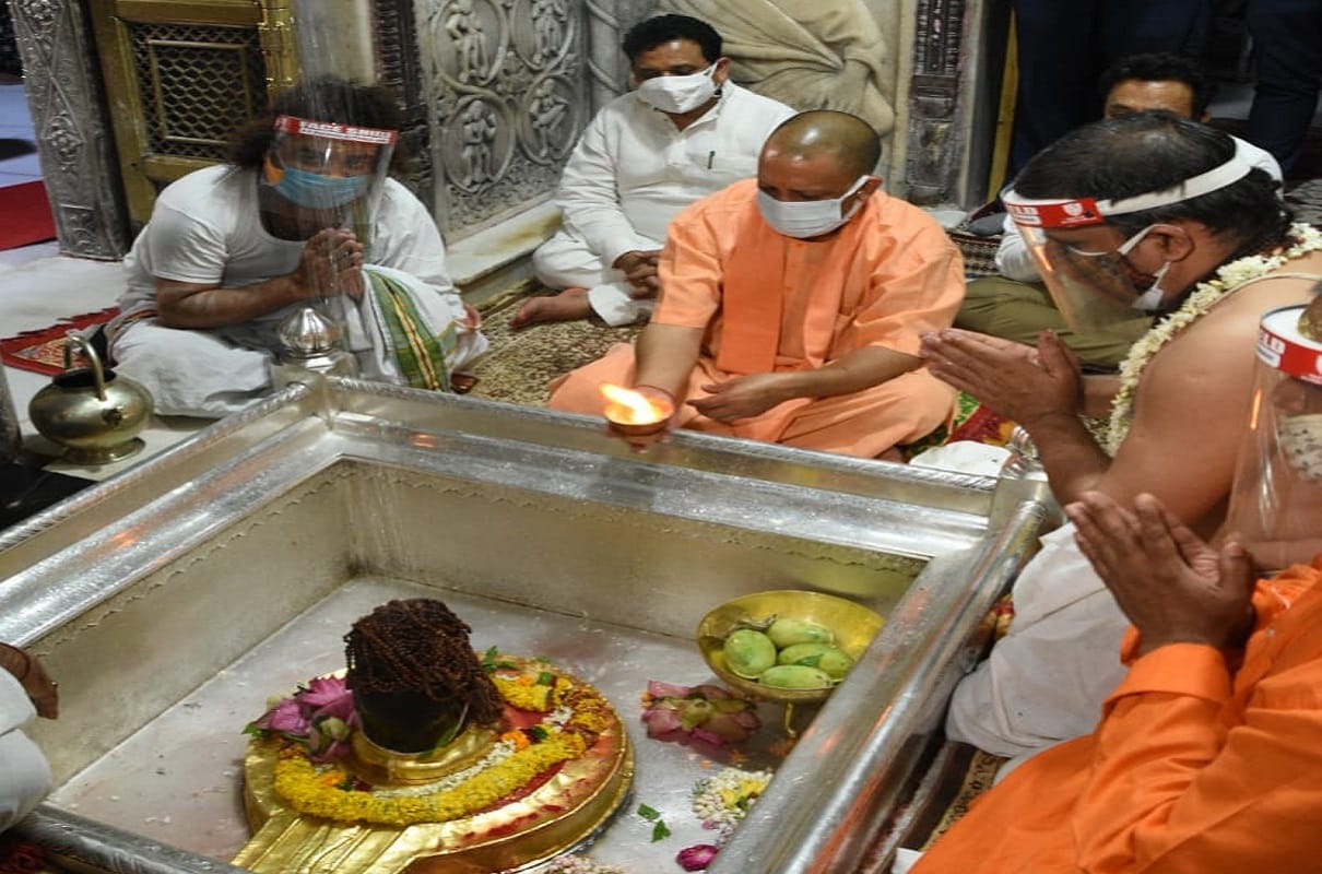 cm yogi adityanath in varanasi do worship in kashi vishwanath temple and donate ration kit to poors