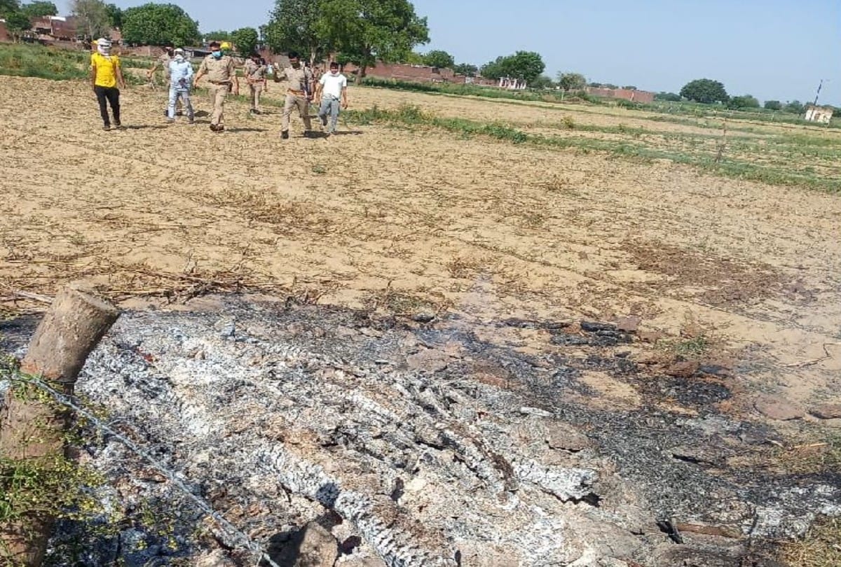 police remove woman half burnt body from pyre in firozabad