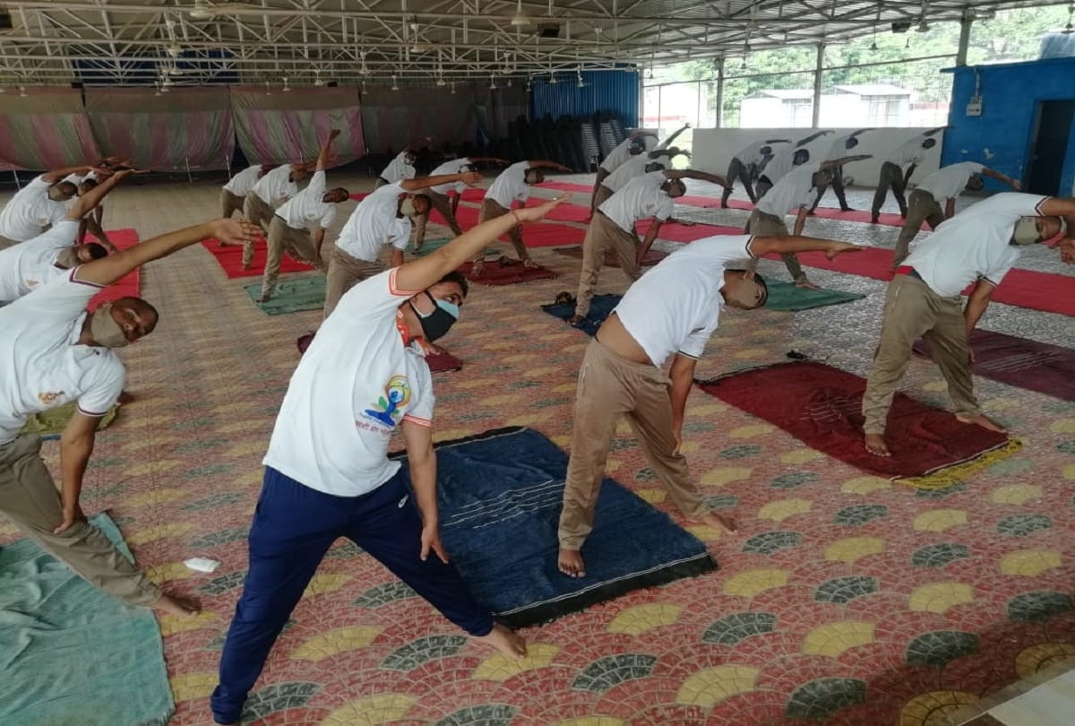 Policemen keeping themselves fit with yoga practicing with social distancing in varanasi Police Line Commissionerate before world yoga day