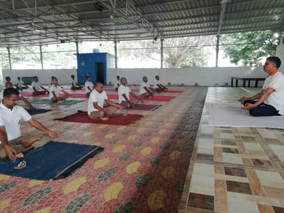 Policemen keeping themselves fit with yoga practicing with social distancing in varanasi Police Line Commissionerate before world yoga day