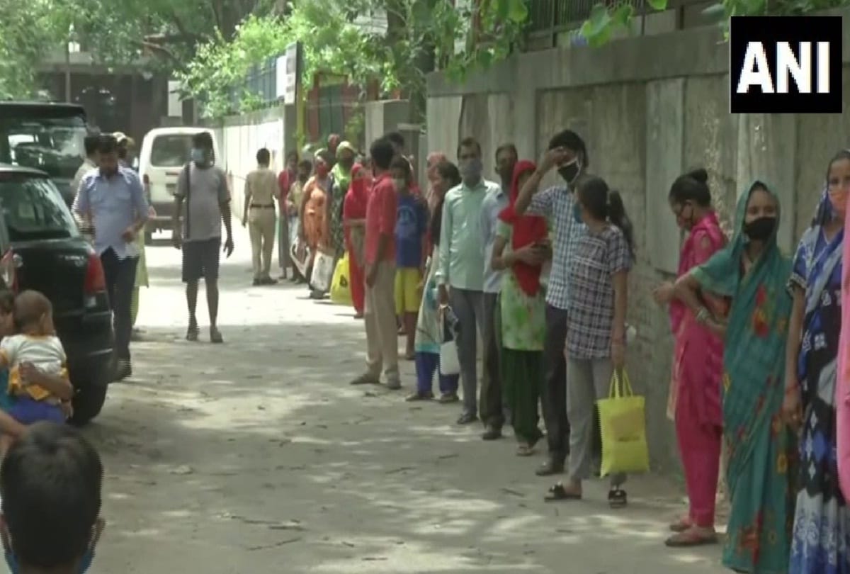 People queue outside a ration distribution centre coming every day for collect but not got