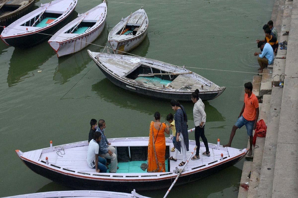 Boats start operating in Ganga in Varanasi, crowd of tourists at ghaat