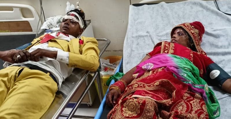 The bride and groom's car collided with a parked truck