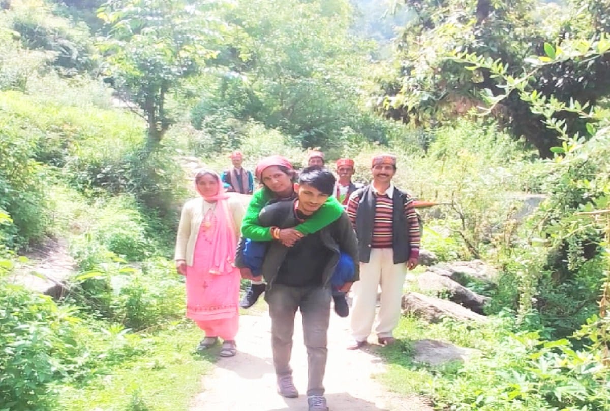 A sick woman carried on back by villagers to the road 25 km away