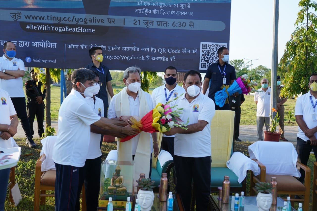 international yoga day 2021 : cm tirath singh rawat does yoga watch photos