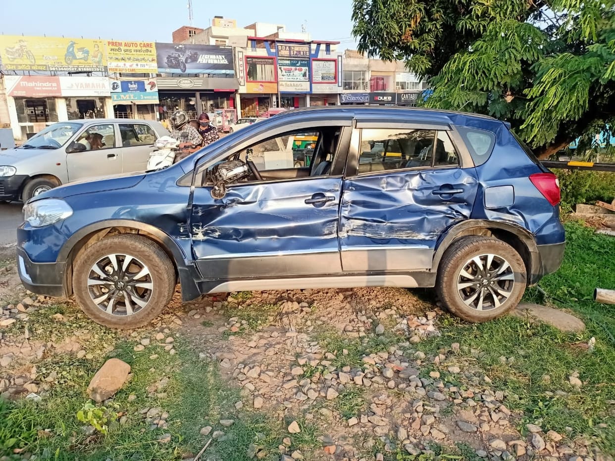 Track maintenance machine collided with car at open railway gate, driver injured