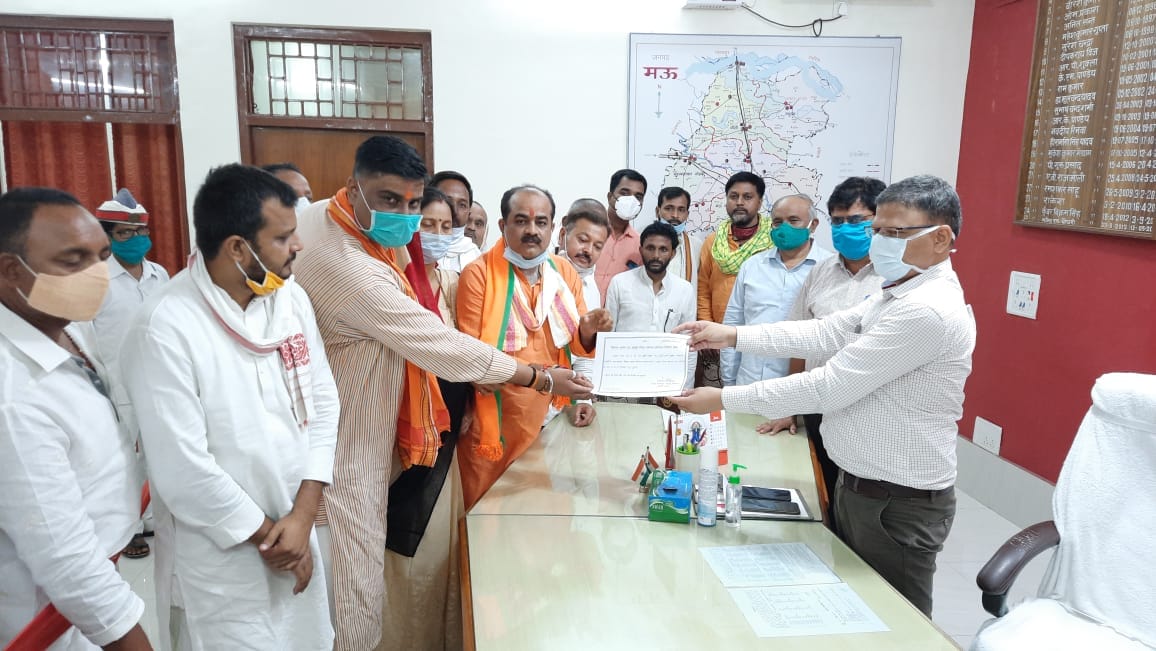 BJP candidate Manoj Rai elected District Panchayat President Mau DM handed over the certificate