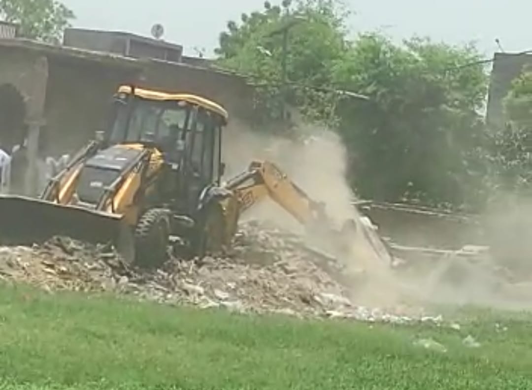 Administration's bulldozer run on the madrassa being built on the pond