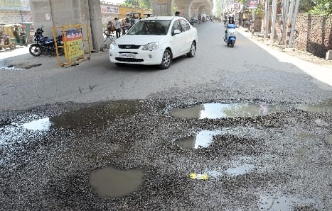 Potholes on the service road of Chaupula bridge, road collapsed in front of Rotary building