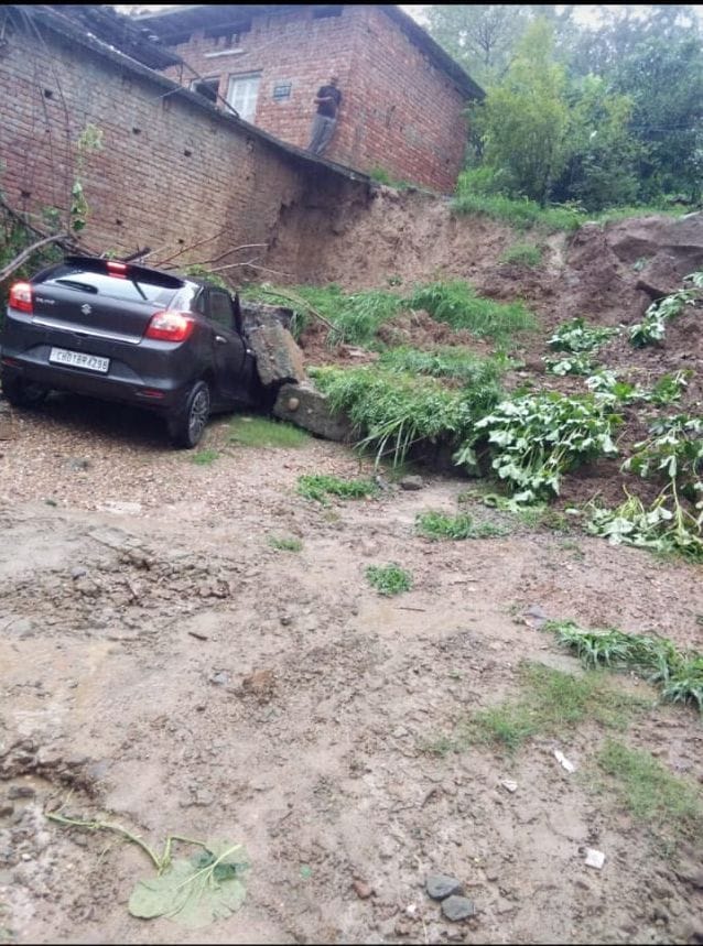 car and scooty stuck in mud