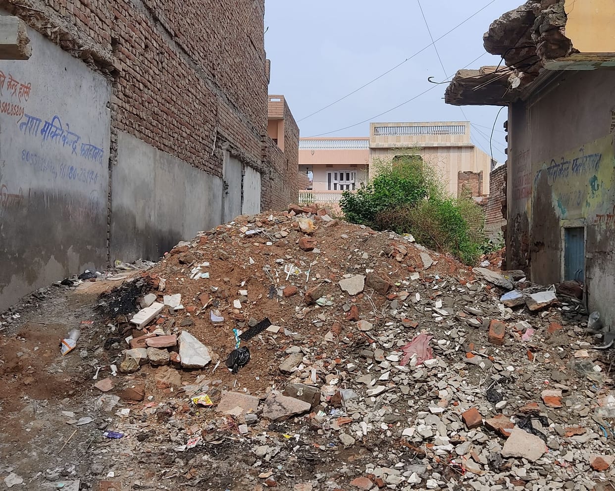 Garbage piles in vacant plot, not cleaned for months