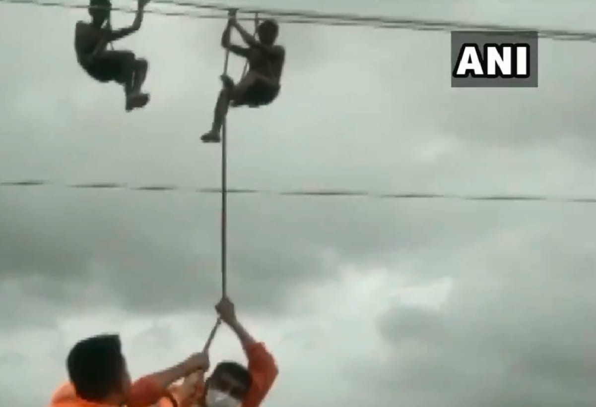NDRF rescued 2 Power Department staff hanging by safety belts on power cables as a raging Surya River flowed below them in Palghar