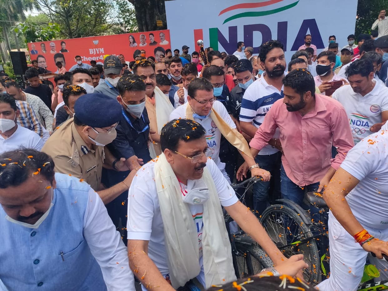 cm pushkar singh dhami cheer tokyo Olympics indian players by riding bicycle