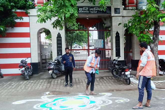 Cleaning and sanitization in temples, decorated with Rangoli