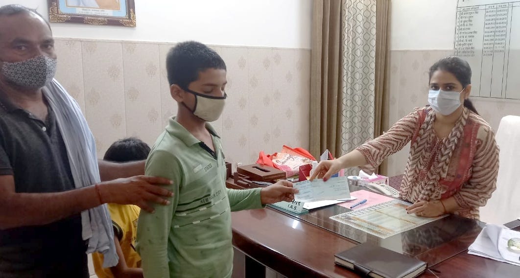 Checks of financial help given to three children