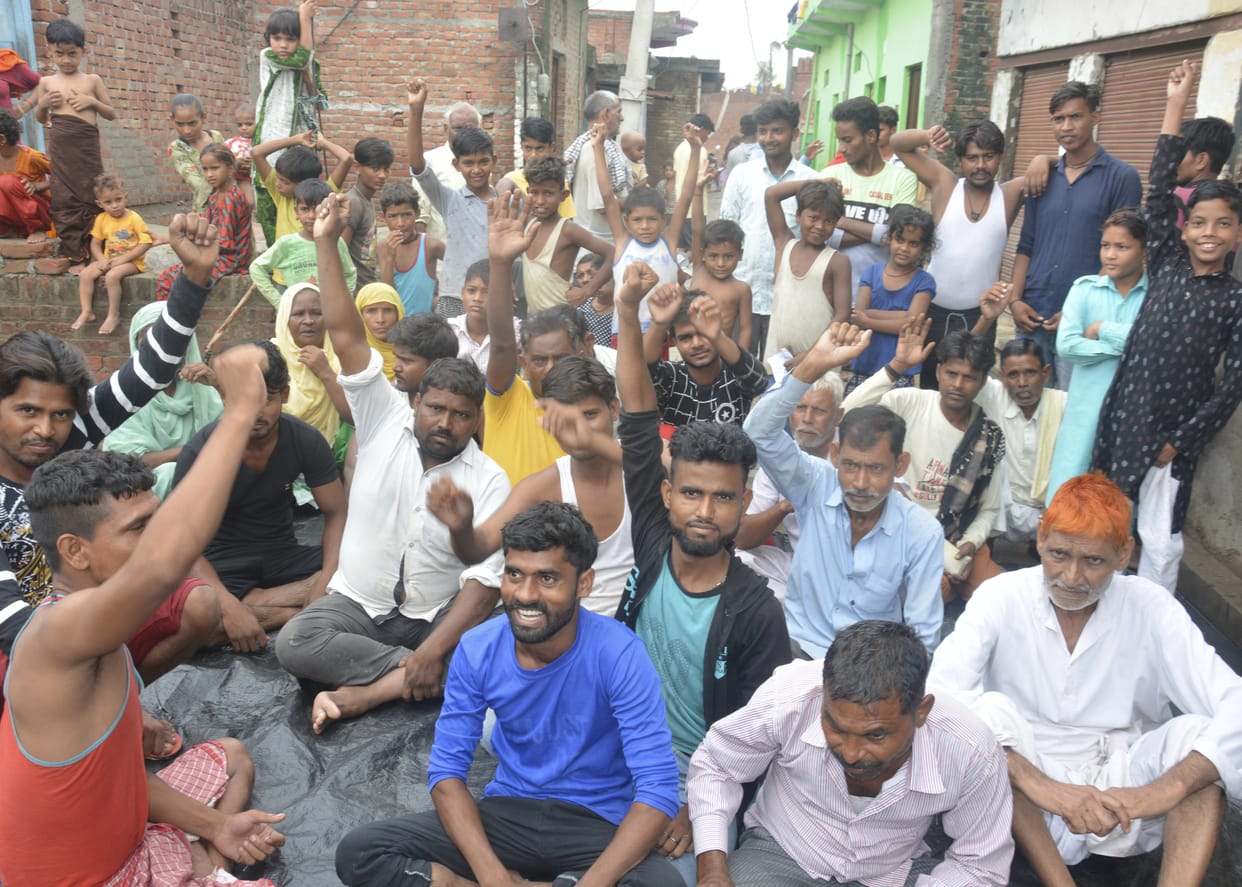 Waterlogging in the streets of Urdu Nagar, people sitting on dharna