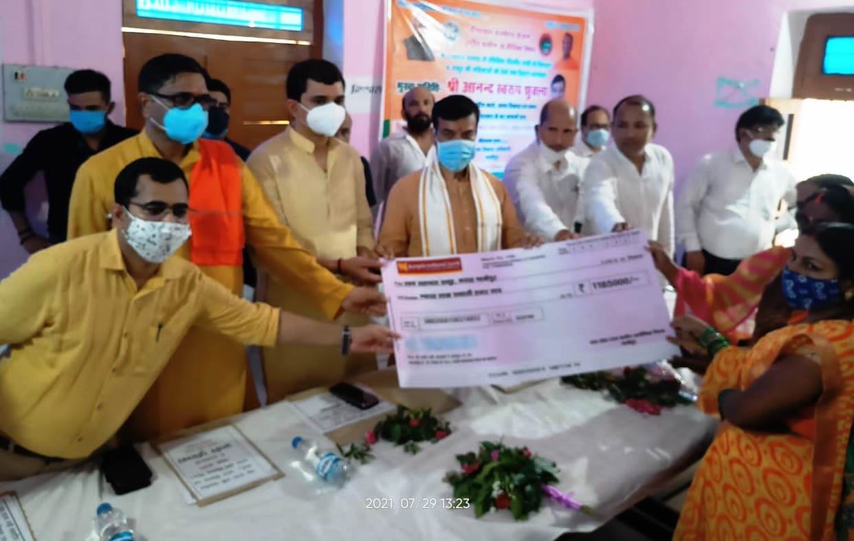 The minister in charge gave checks to the women of the group