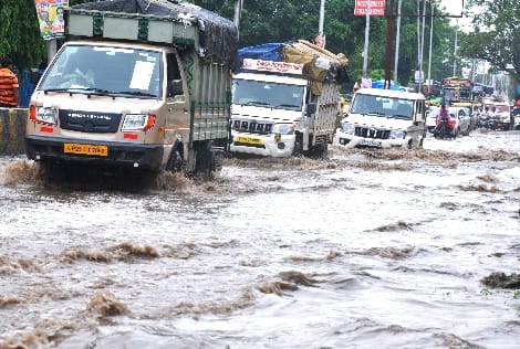 Fort road again became a pond due to rain, people dragging bikes on foot