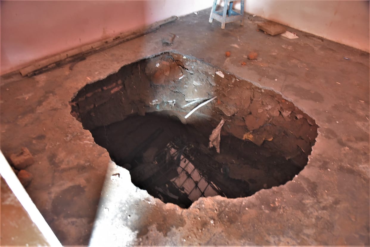 The floor of the house built over the drain in Indira Colony was washed away with rain water
