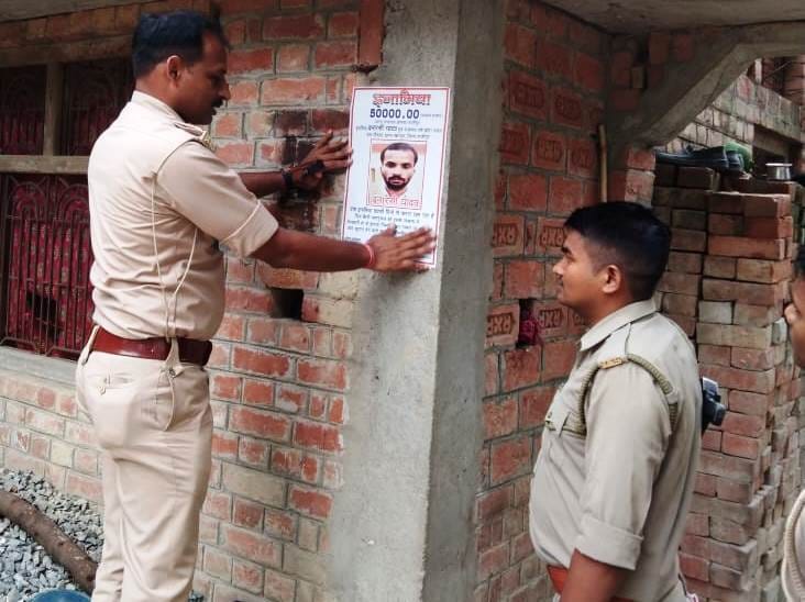Police pasting posters to nab the accused of double murder