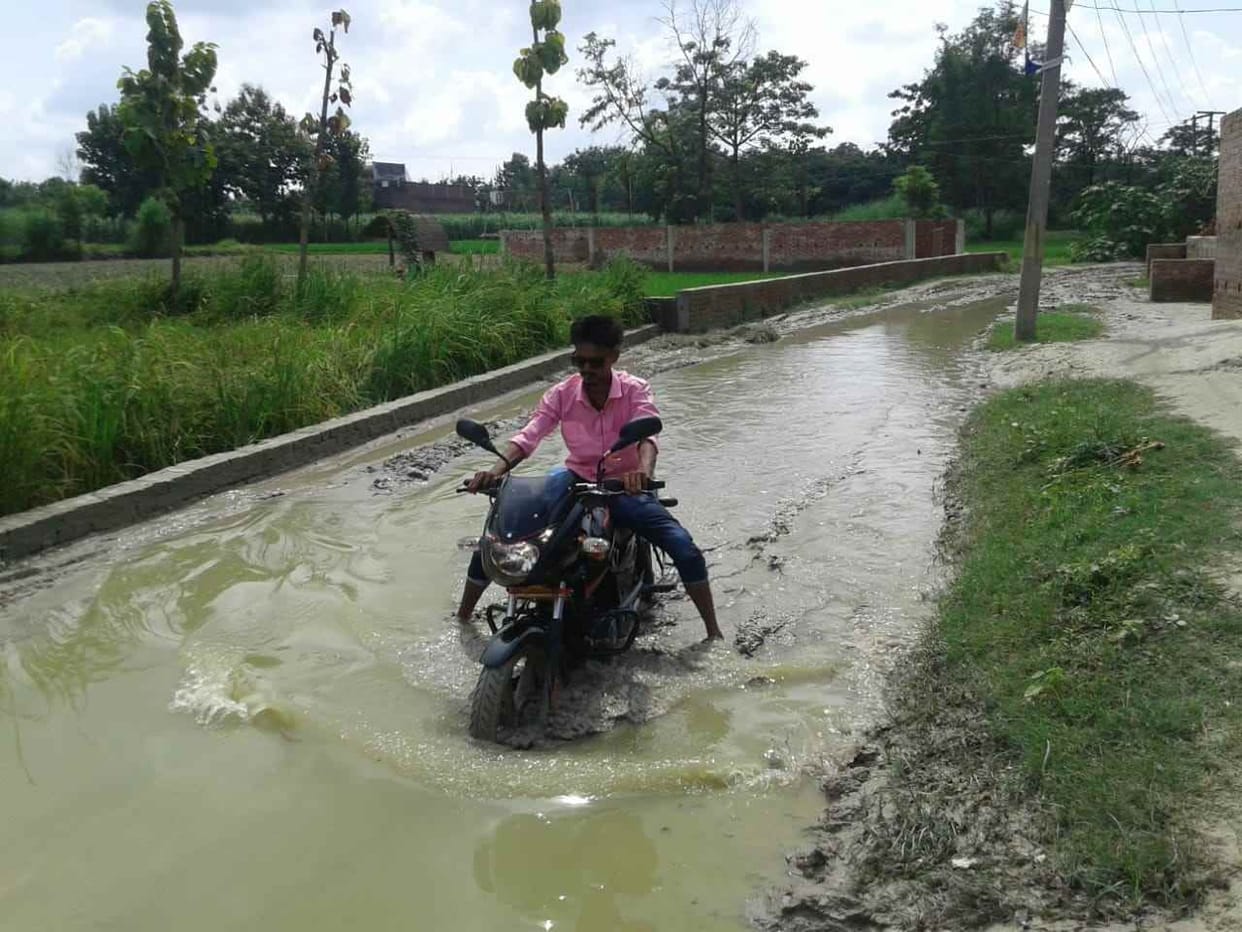 Ten families are compelled to go home through a knee-filled watery road