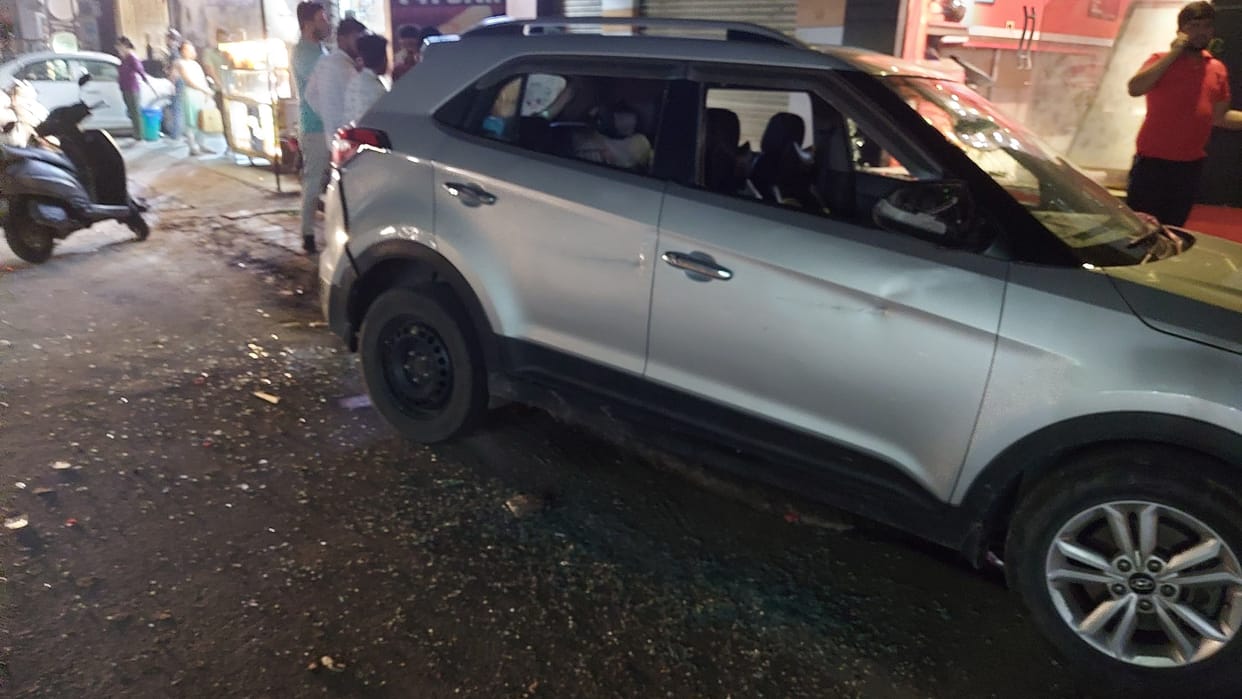 Two youths absconding by breaking the glass of a parked car