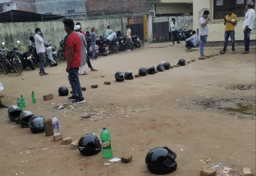 Line with bricks, bottles and helmets instead of men