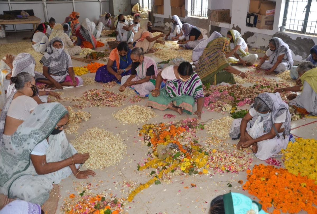 Widow women making incense sticks with flowers offered in Banke Bihari temple in Vrindavan
