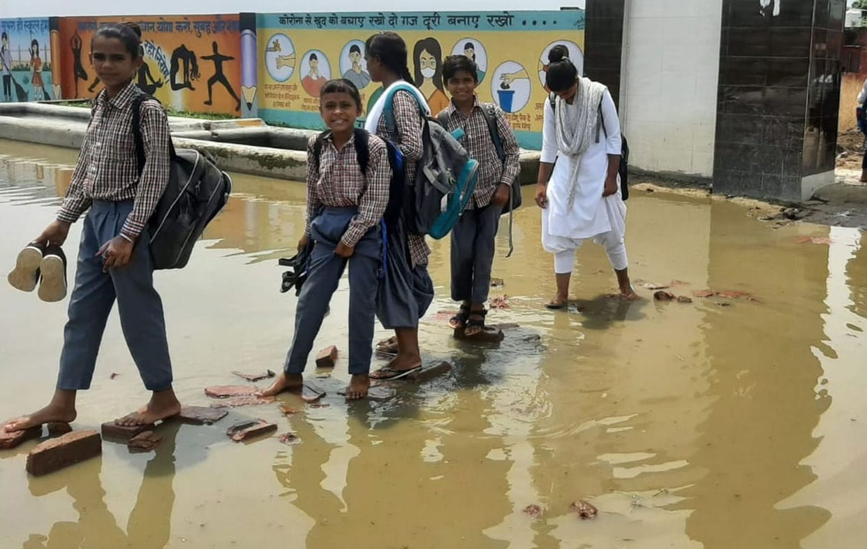 Girls of village Mataur reaching school by passing through dirty water