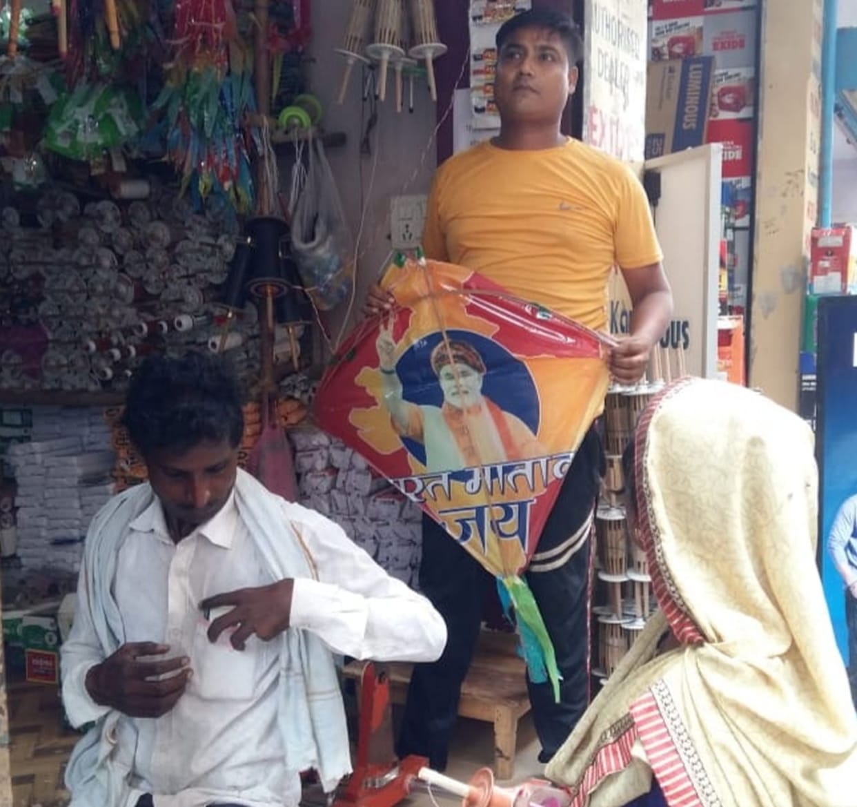 There is a political atmosphere in the market decorated for kite flying, the faces of the leaders on the kites