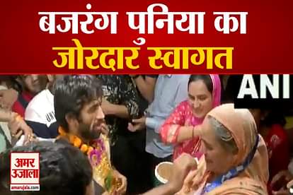 olympic Bronze medallist wrestler Bajrang Punia receives a rousing welcome from his family and locals outside his residence in Sonipat.