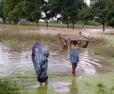 Villagers spending the night on the roadside waiting for the flood to subside