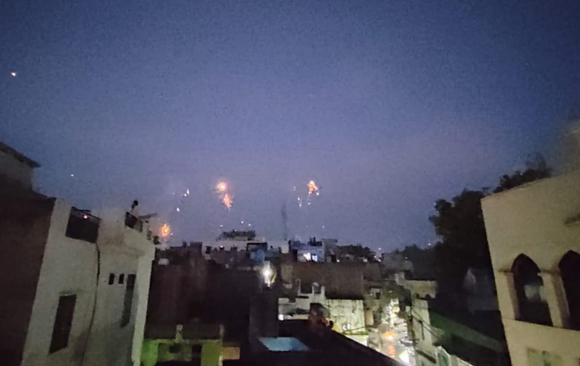 The color of henna mounted on the hands and colorful kites flying in the sky