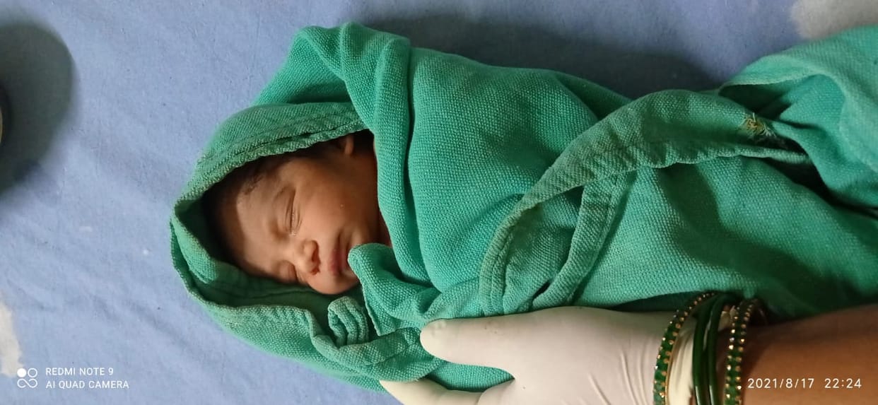 Newborn girl thrown in the bushes wrapped in a sack