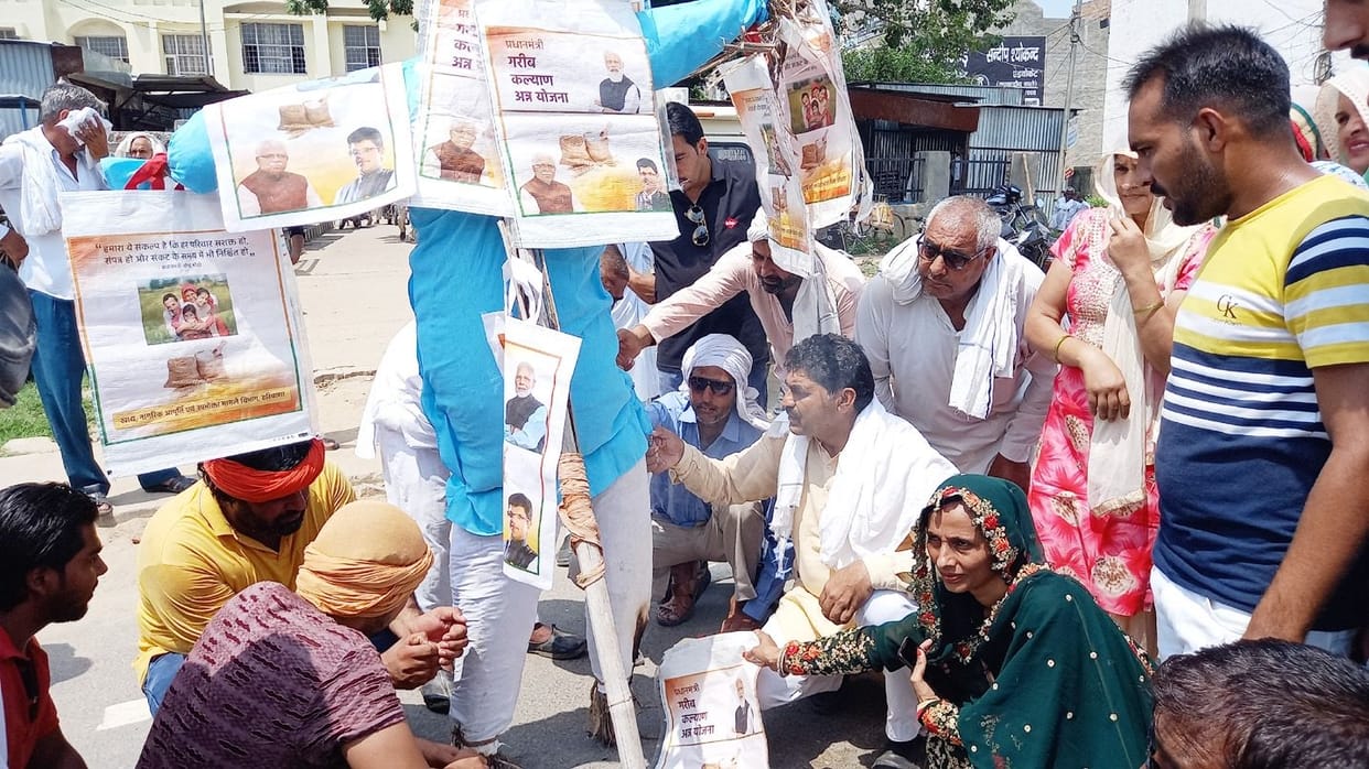 Express anger over putting photos of PM and CM on ration bags
