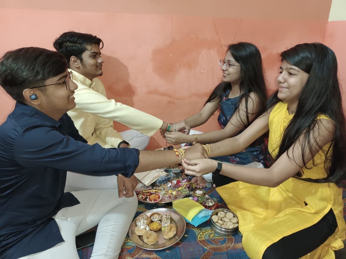 Sisters tie love strings on brother's wrist