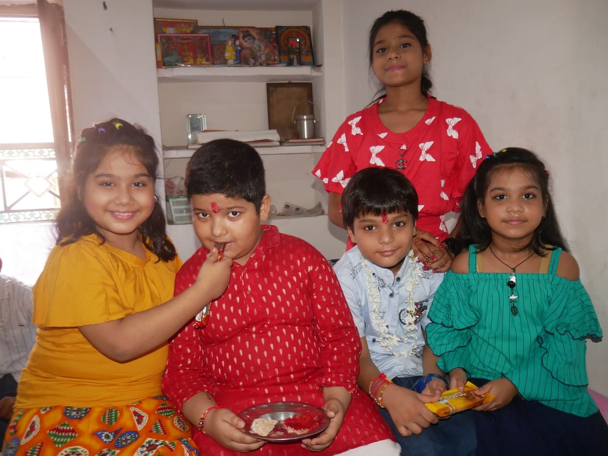Sisters tie the thread of protection on the wrists of brothers