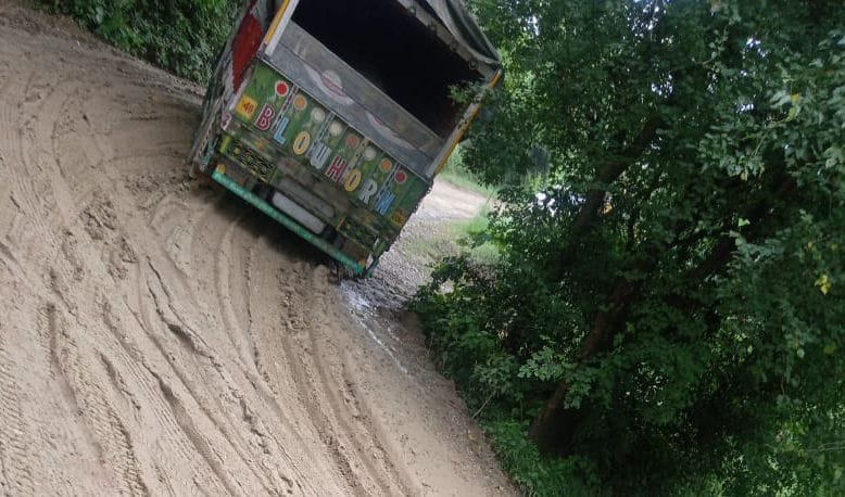 truck stuck in mud, road closed