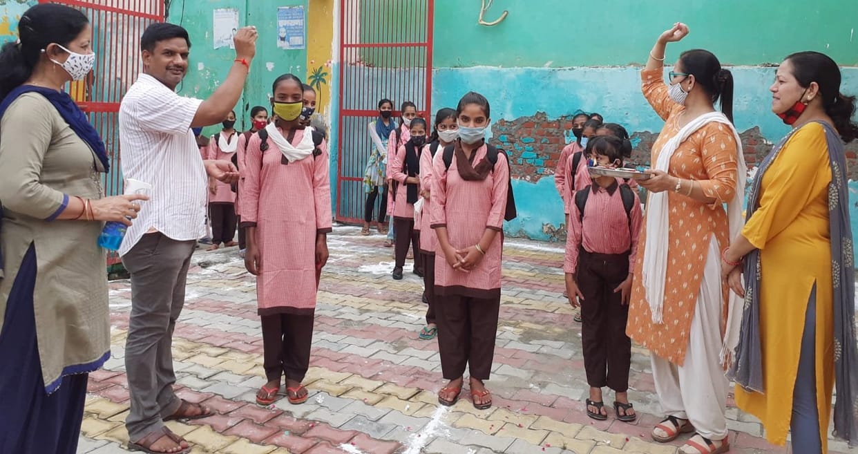Students were welcomed by applying tilak, showering flowers