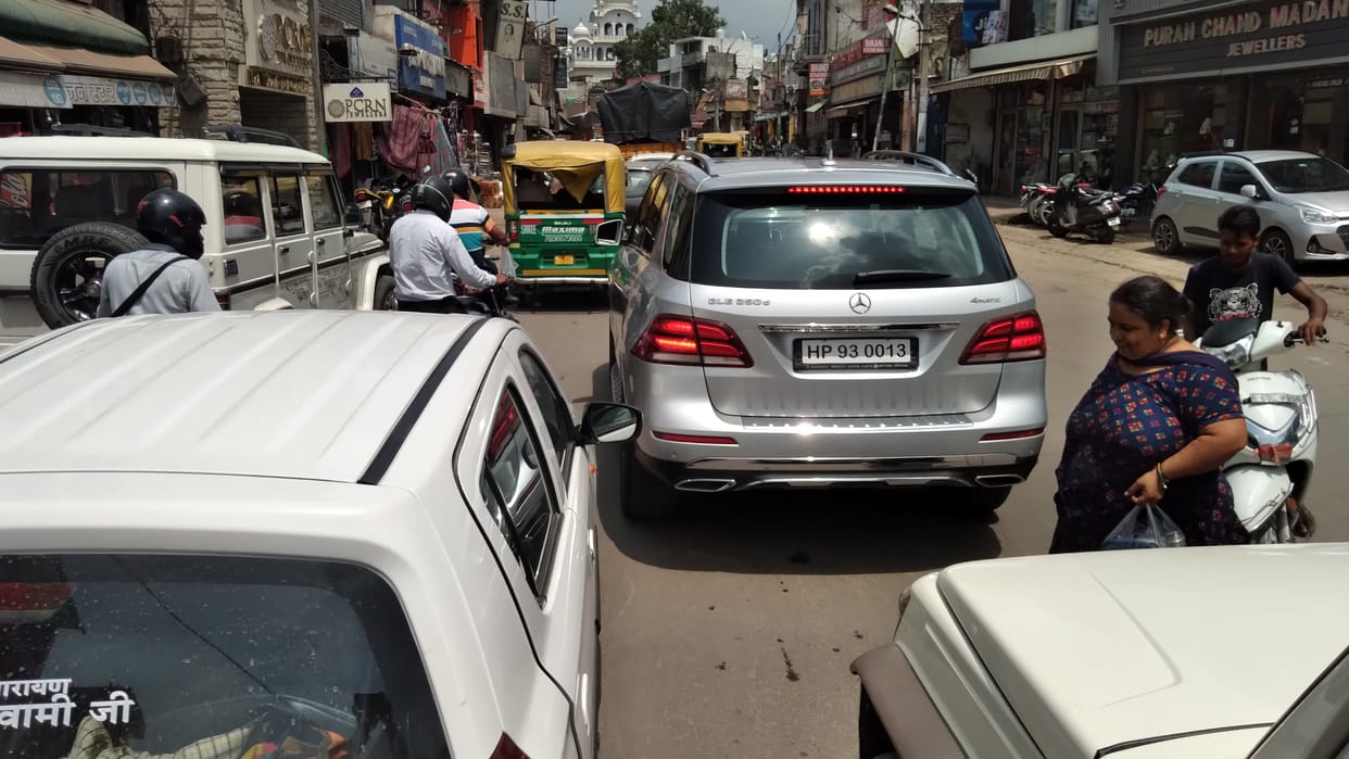 Heavy vehicles passing through Pinjore's main market, no parking facilities...