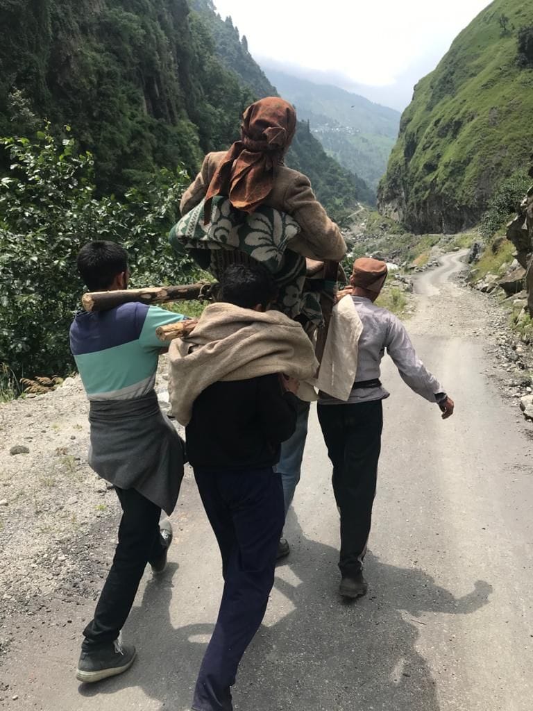 The sick old lady was taken to the hospital by foot