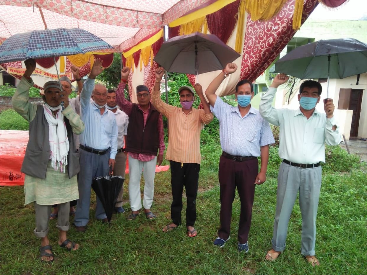 Mandalsera residents demonstrated the demand for road and bridge by wearing an umbrella