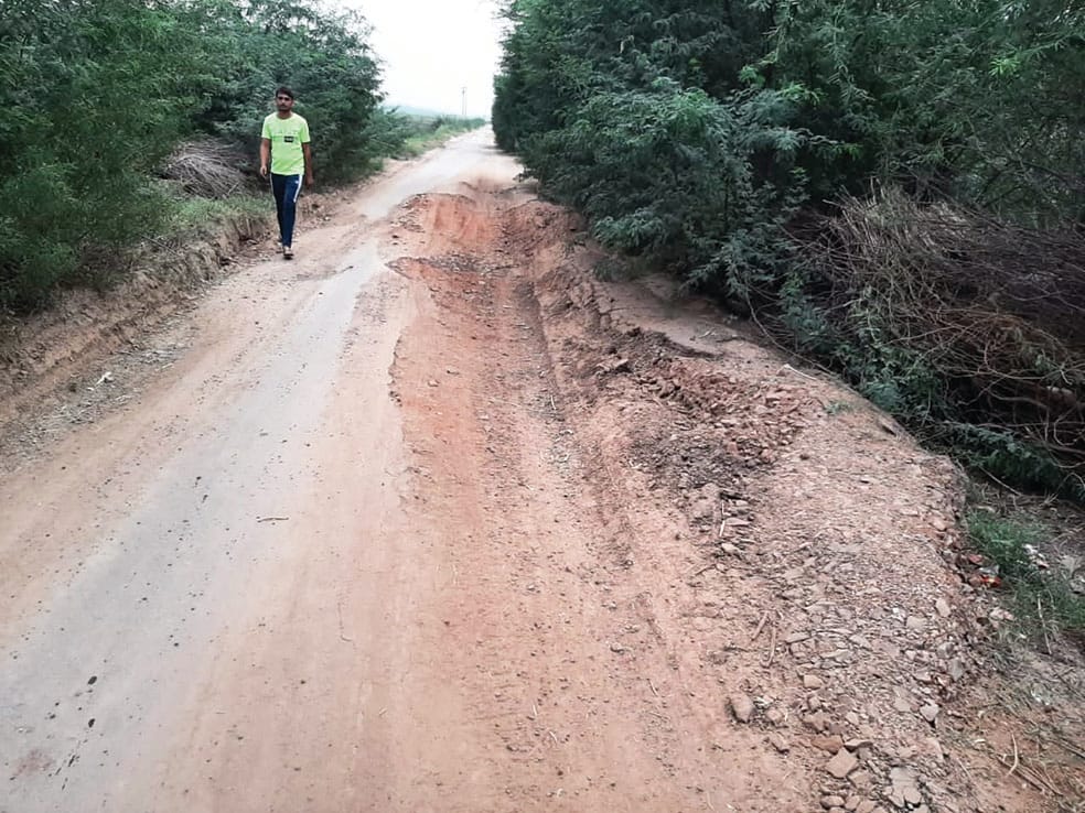 Driver and passersby upset due to potholes on the road