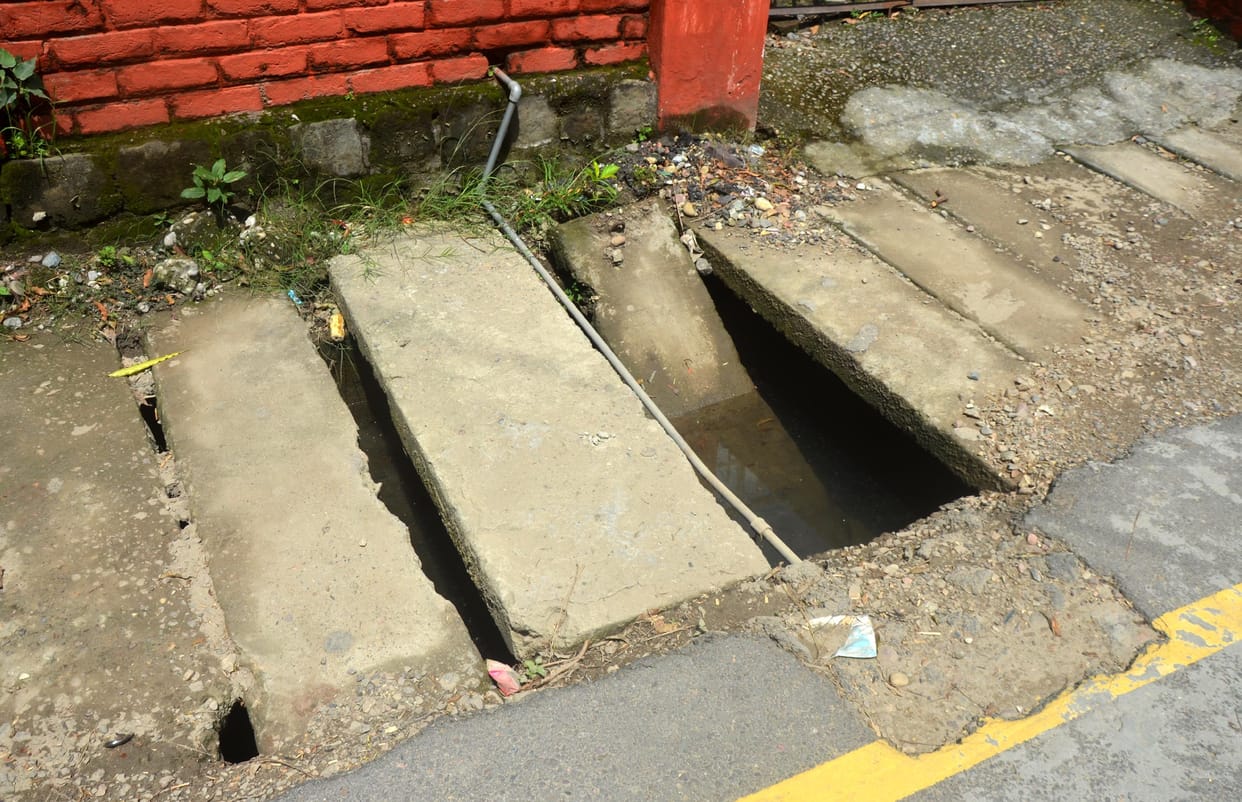 Broken slabs of pavement in the city, danger of accident